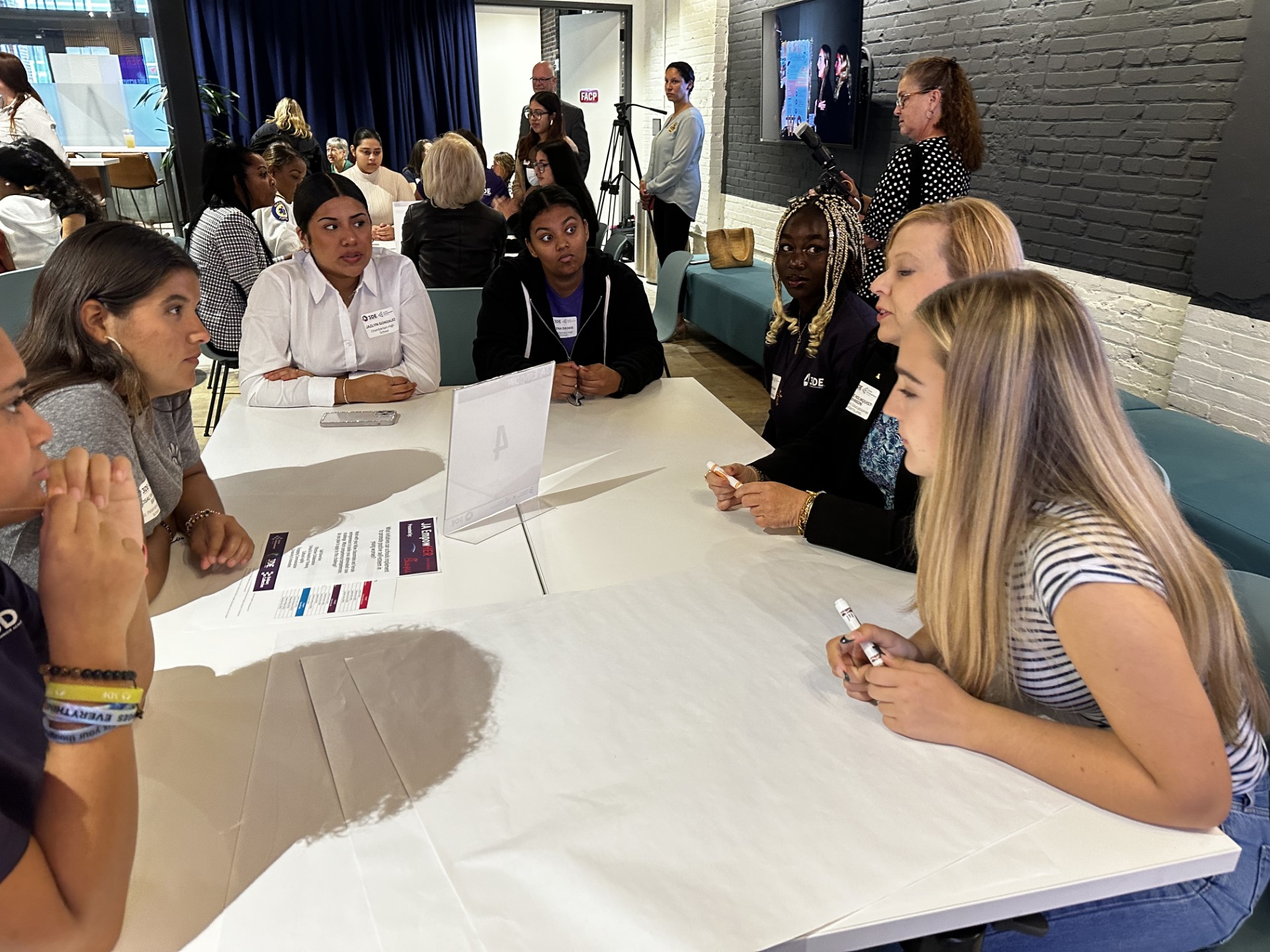 A group of people sitting at a tableDescription automatically generated